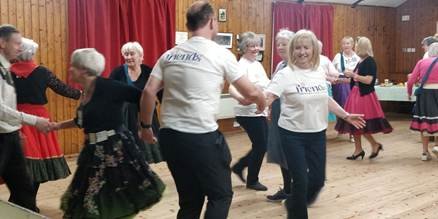 A group of people dancing in a room

AI-generated content may be incorrect.